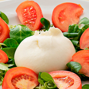 Burratina with cherry tomatoes and mixed greens
